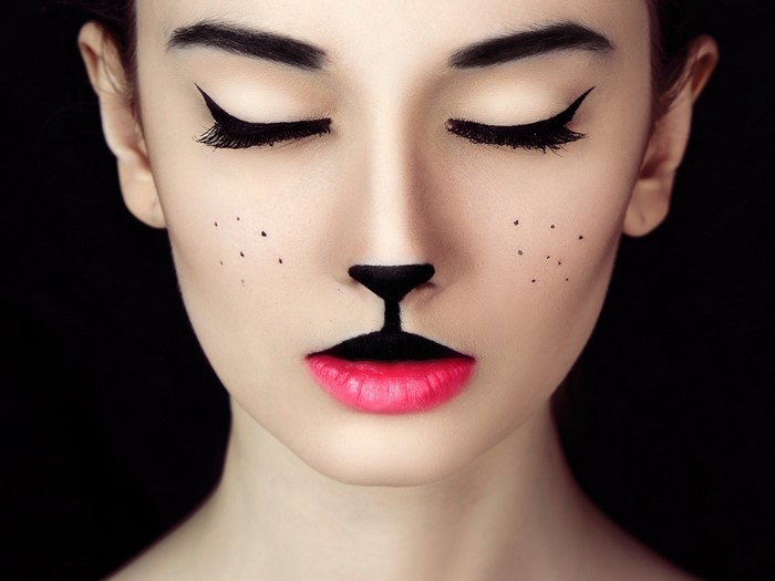 Woman with cat makeup and closed eyes