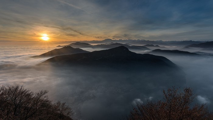 Sunrise over misty mountains and a lake