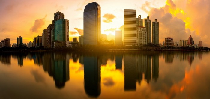 City skyline at sunset with water reflection