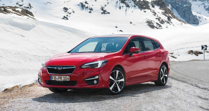 Red Subaru Impreza 5-door hatchback in snowy mountains