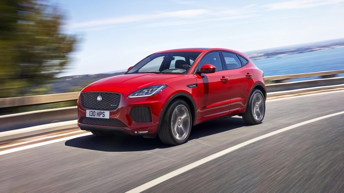 Red Jaguar E-Pace driving on a coastal road