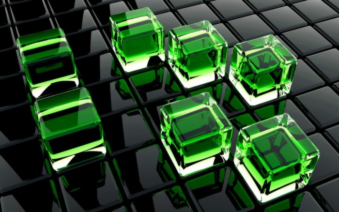 Green glass cubes on a black tiled surface