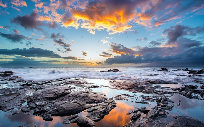 Ocean waves crashing on rocky shore at sunset 4K