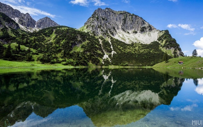 Serene Lake Reflection at Alpine Mountain Range