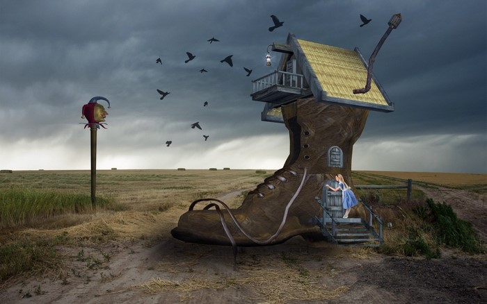 A surreal landscape with a boot house and a jester sign