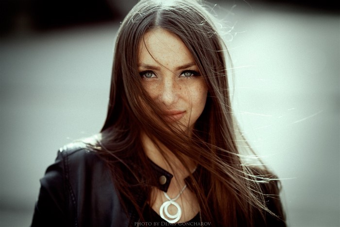 Portrait of a woman with freckles and windblown hair