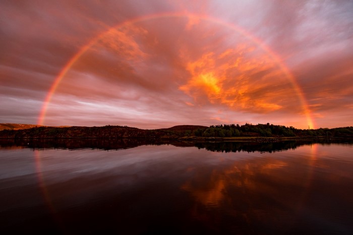 Rainbow over a lake at sunset