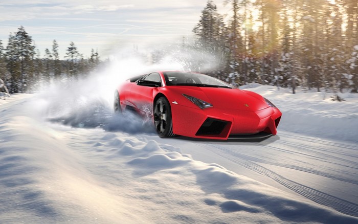 Red Lamborghini Aventador driving on a snowy road