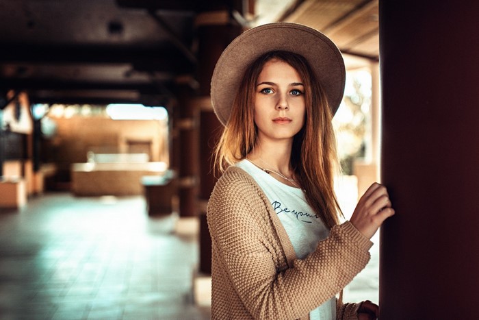 Woman wearing a hat and cardigan