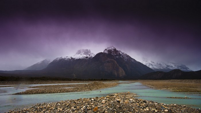 Mountain range with river and purple sky