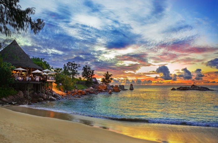 Tropical beach restaurant at sunset with ocean view