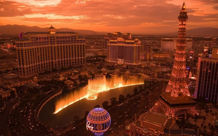 Las Vegas Strip at dusk with Bellagio fountains and Eiffel Tower replica
