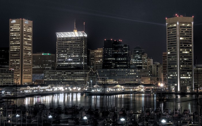 Baltimore Inner Harbor cityscape at night with boats