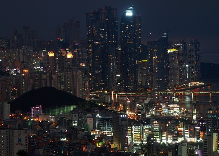 Night cityscape with illuminated skyscrapers and a bridge