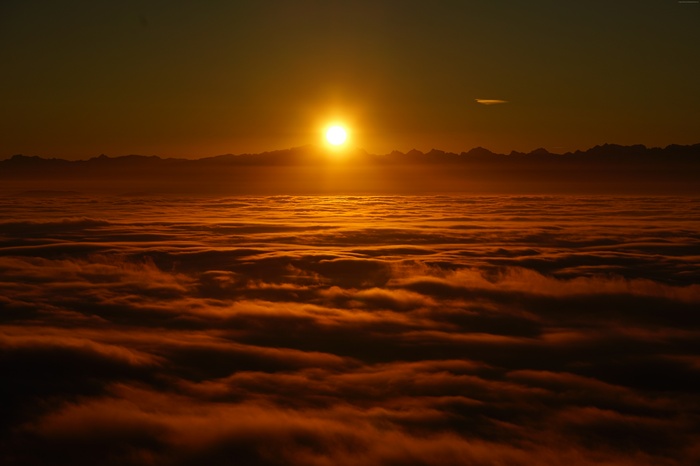 Sunrise over clouds and mountains