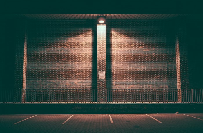 Brick wall with overhead light at night