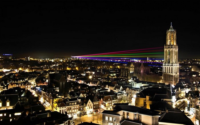 Night cityscape of Utrecht with Dom Tower and laser show