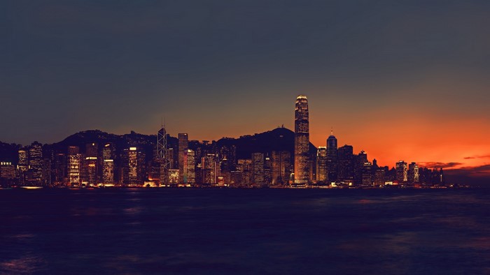 Hong Kong skyline at sunset over the sea