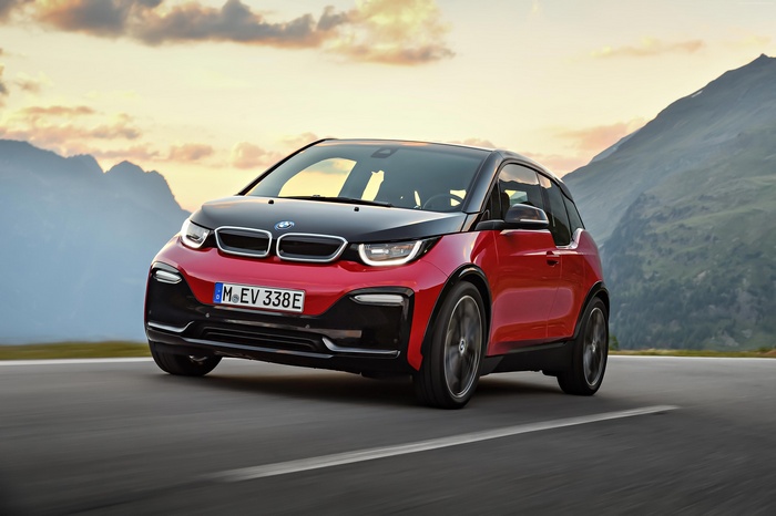 Red BMW i3s electric car driving on a mountain road