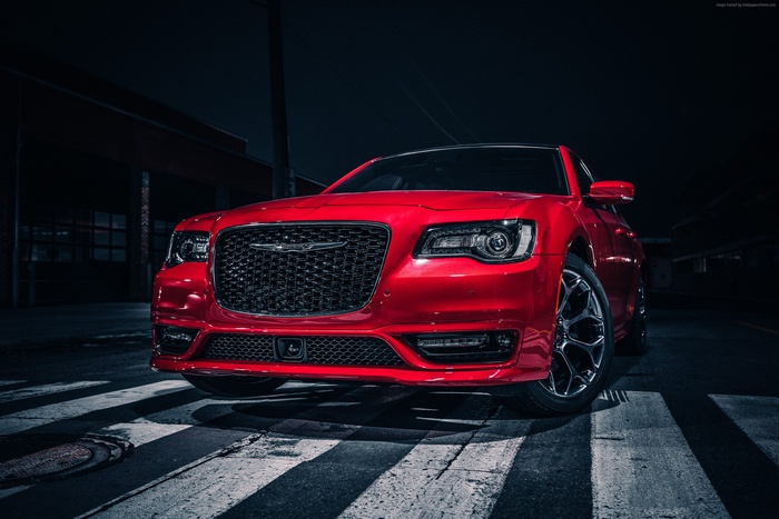 Red Chrysler 300S parked on a street at night