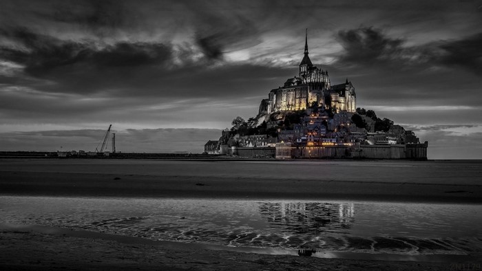 Mont Saint-Michel castle at dusk with reflection