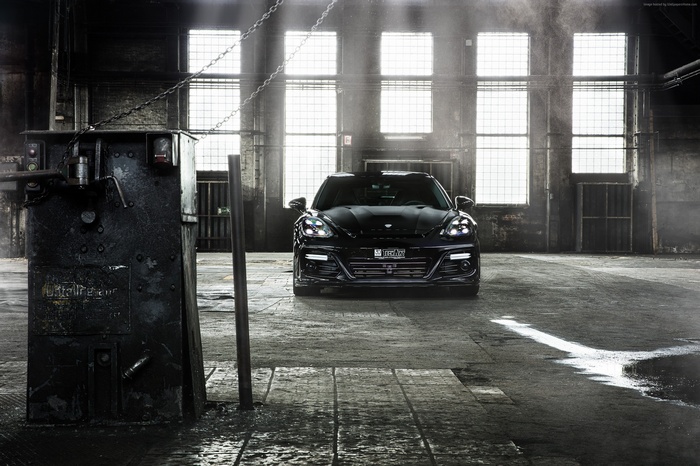Black Porsche Panamera Grand GT in industrial garage