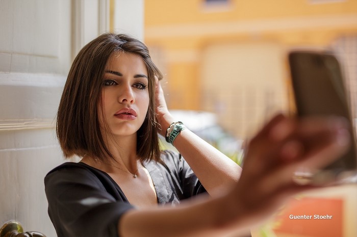 Woman taking a selfie with her phone