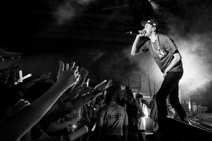 Rapper performing on stage for a crowd