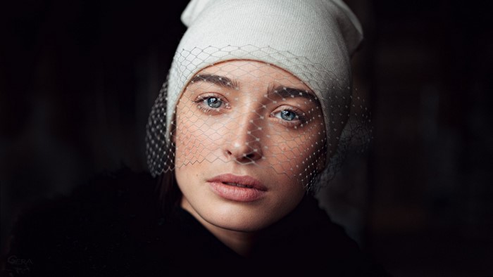 Woman wearing a white beanie and veil