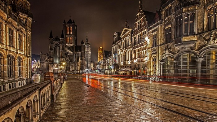 City street at night with historic buildings and tram tracks