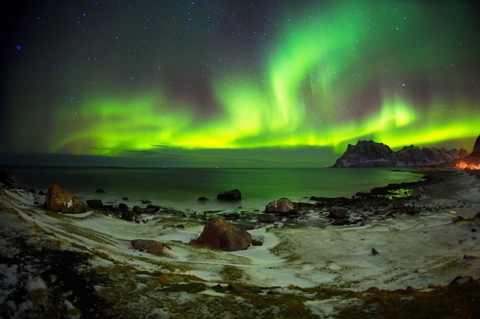 Aurora Borealis over a snowy coast