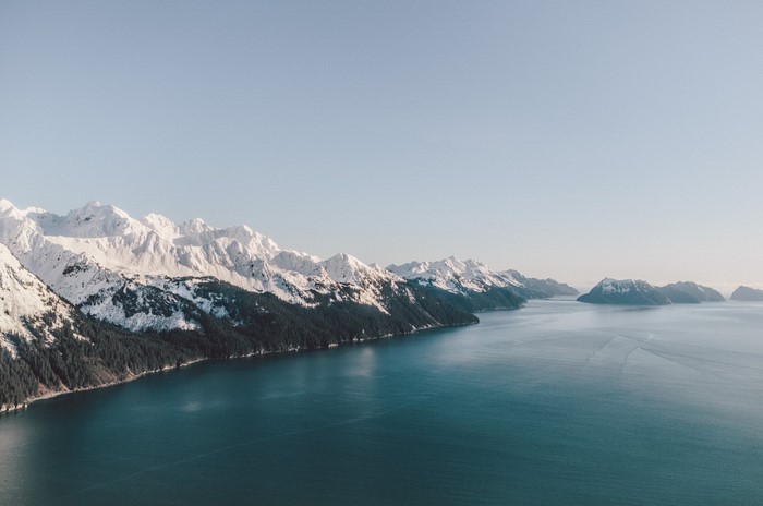 Snow-capped mountains meet the sea in a fjord