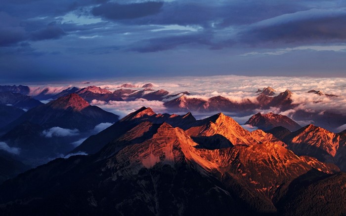 Mountain range at sunset with clouds