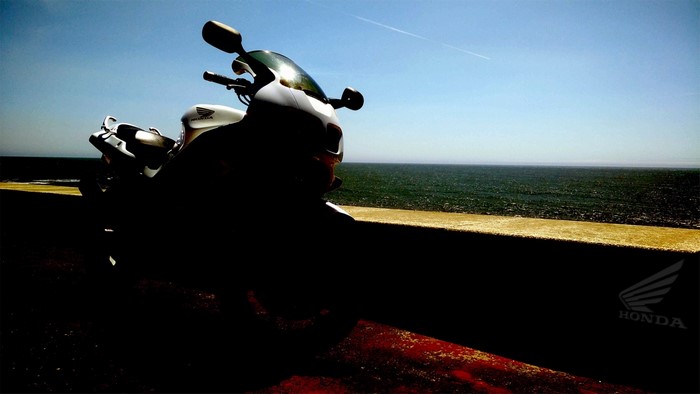 Honda VFR motorcycle parked by the sea