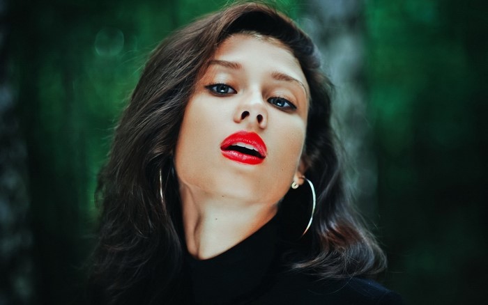 Woman with red lipstick and hoop earrings