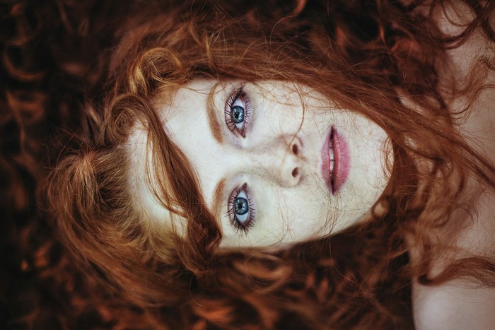 Close up portrait of a redhead woman with blue eyes