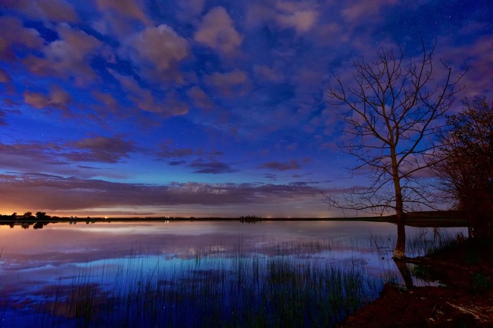Twilight sky over a calm lake with reflections