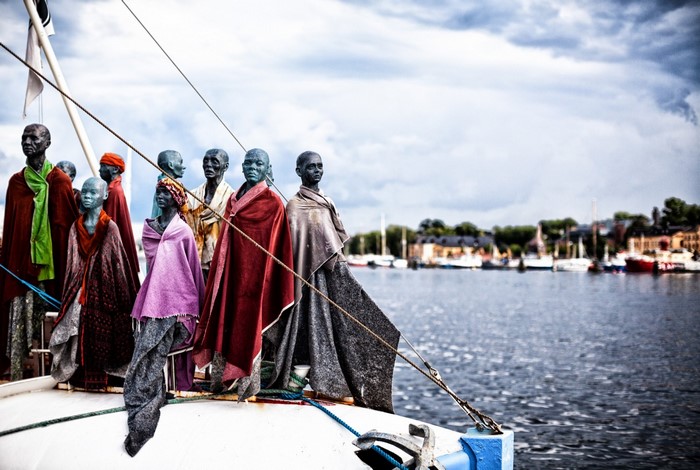 Statues on a boat in a harbor