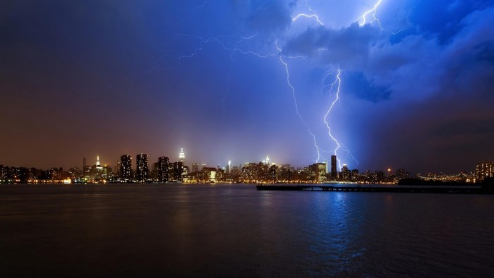 New York City skyline during a lightning storm over the water