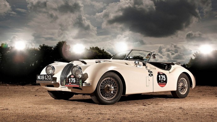 Cream colored Jaguar XK120 convertible race car