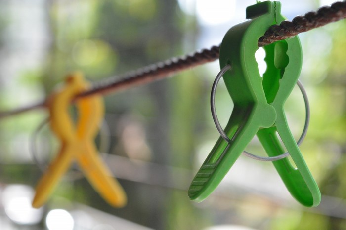 Green and yellow clothespins on a clothesline