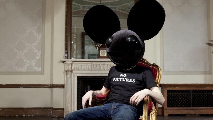 Deadmau5 sitting in a chair wearing a t-shirt
