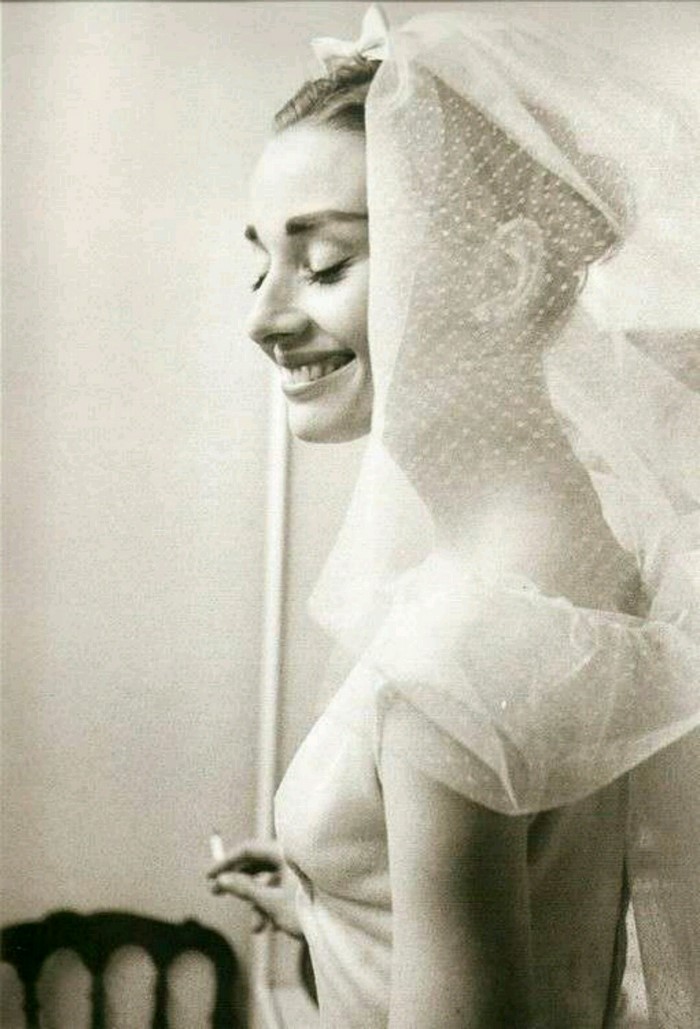 Audrey Hepburn smoking under a veil