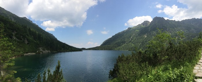 Mountain lake surrounded by forested slopes and rocky peaks