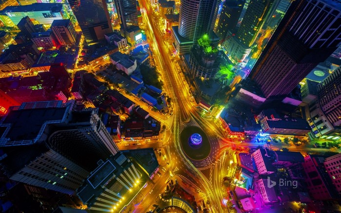 Aerial view of a city at night with colorful lights
