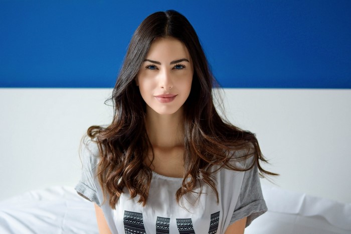 Woman with long brown hair and blue eyes