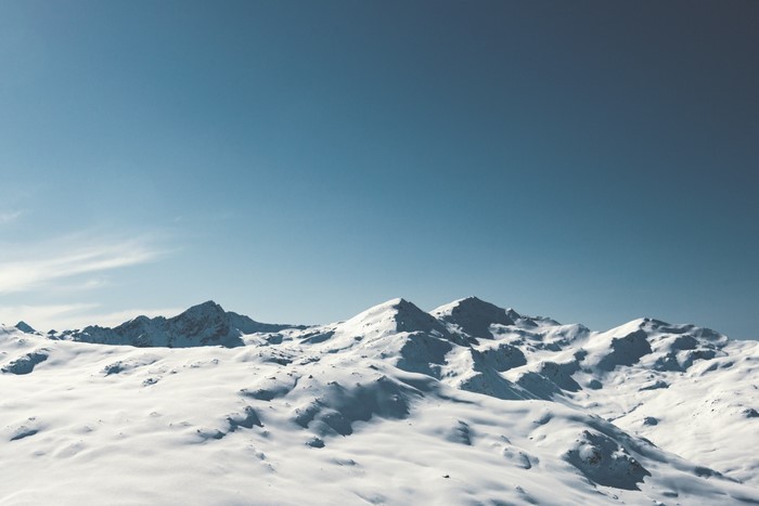 Snow-covered mountains under a clear blue sky