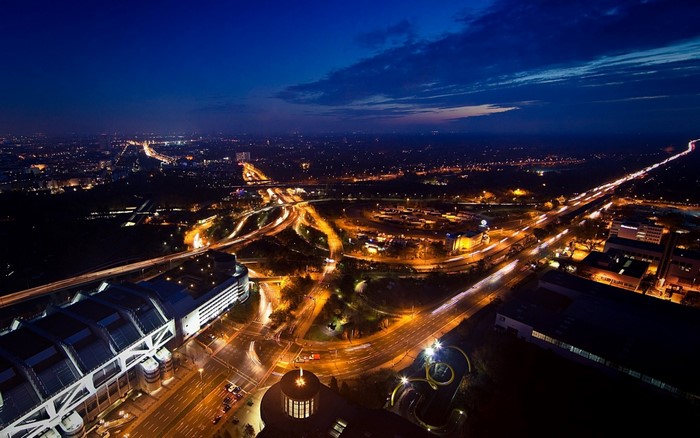 Aerial view of a city at night with illuminated roads and buildings