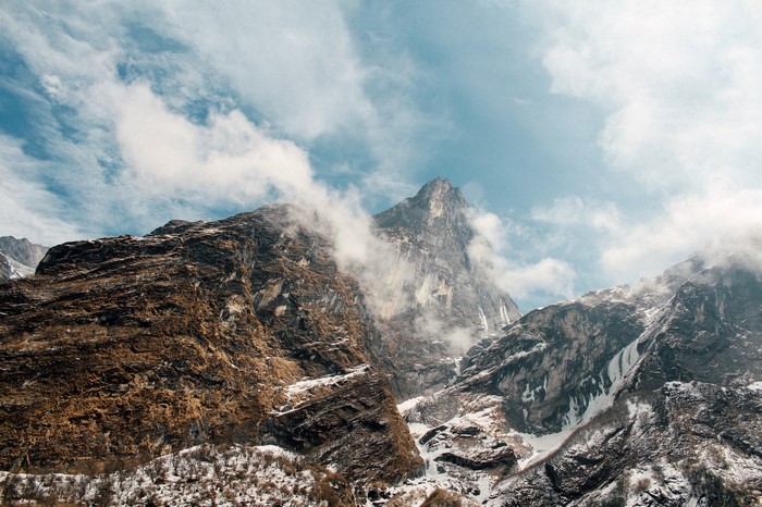 Rocky mountains with snow and clouds