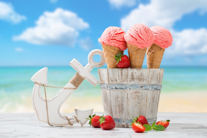 Strawberry ice cream cones with anchor and beach background